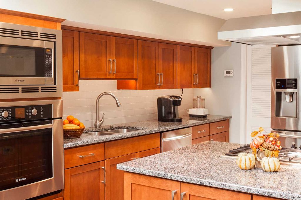 Maple wood cabinets with a Brandywine stain plus gray-toned granite countertops