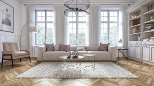 Elegant living room with herringbone wood flooring, modern rug design, and lots of windows