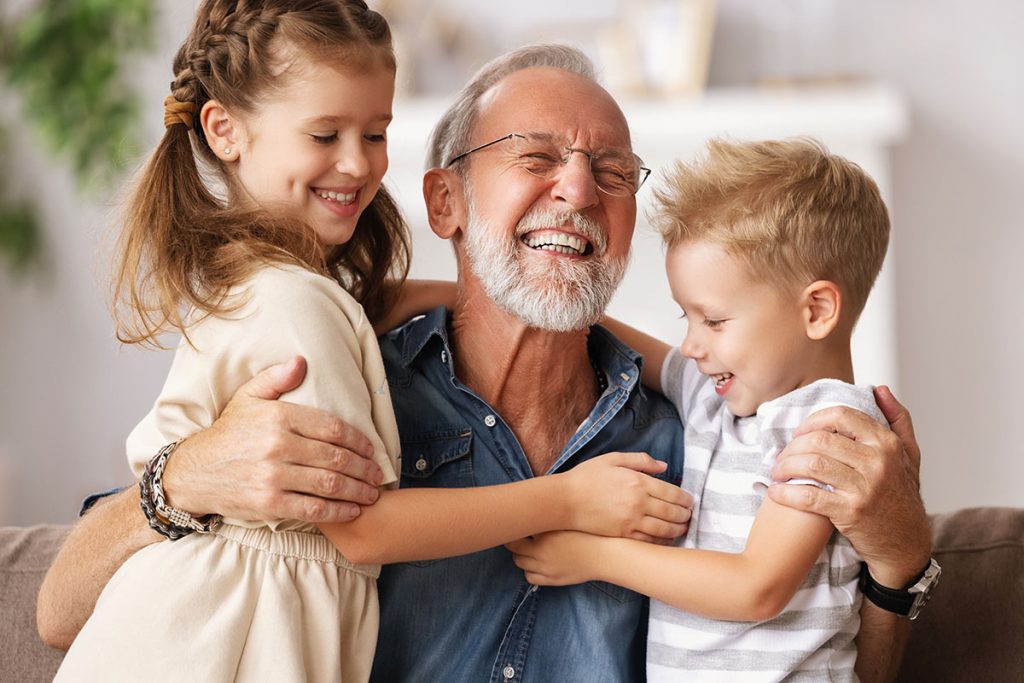 Multigenerational living with grandfather and grandchildren laughing