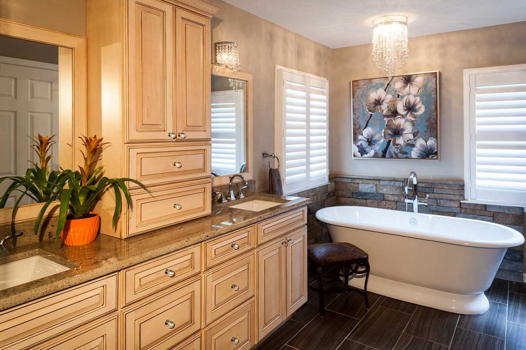 Elegant bathroom with upgraded cabinets, lighting, and wall coverings to look custom-built