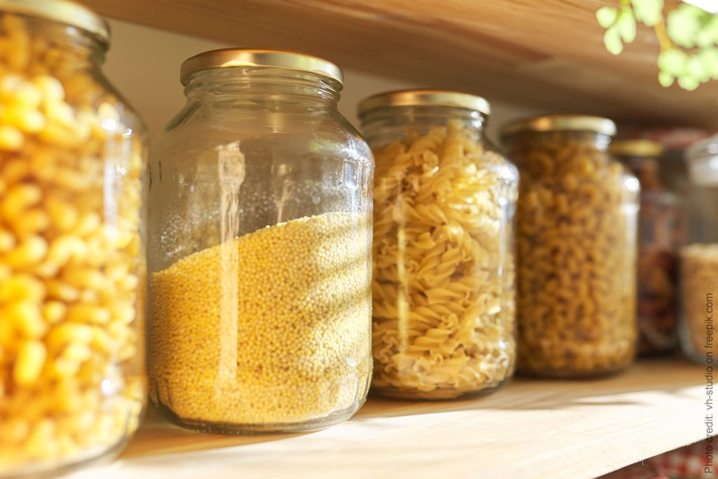 Prep kitchen food pantry with jars of pasta and grains