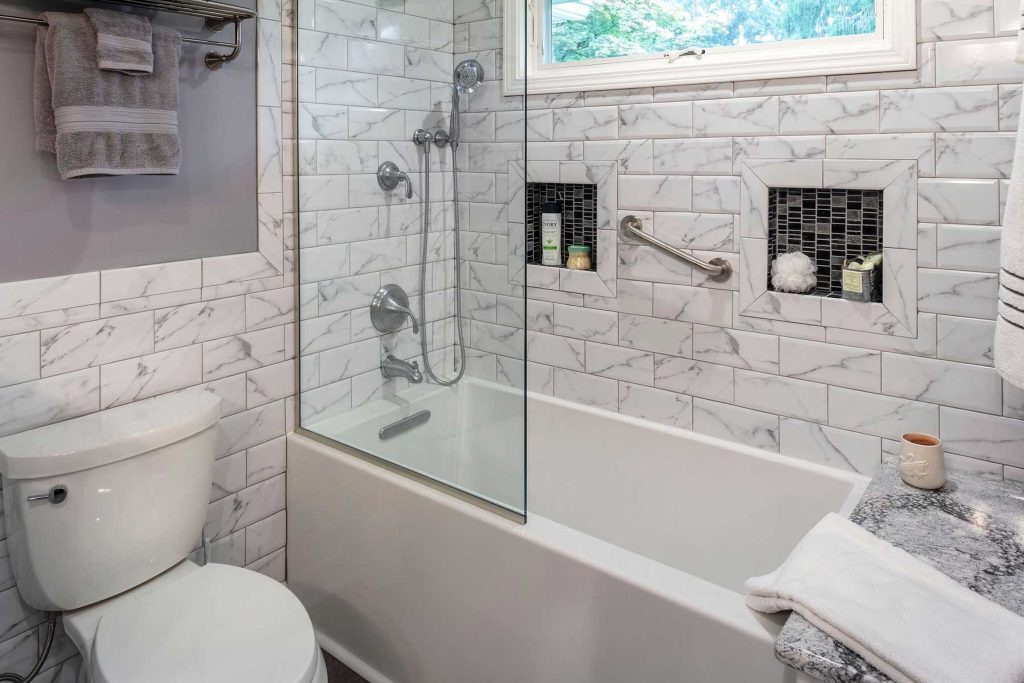 Bathroom remodel includes timeless materials in the design like subway tiles