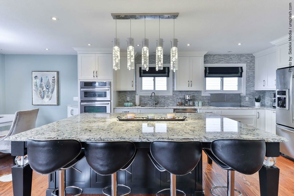 Trendy looking kitchen with large island and unique pendant lights