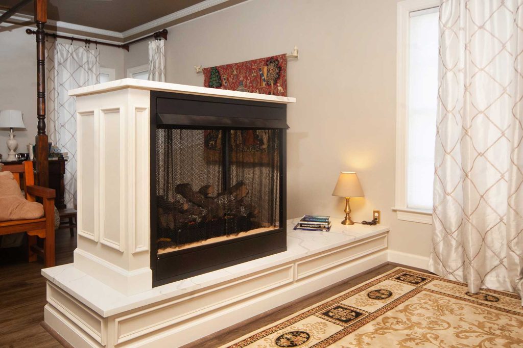 Gas fireplace in master bedroom that is open on both sides is an excellent example of home upgrades you should consider.