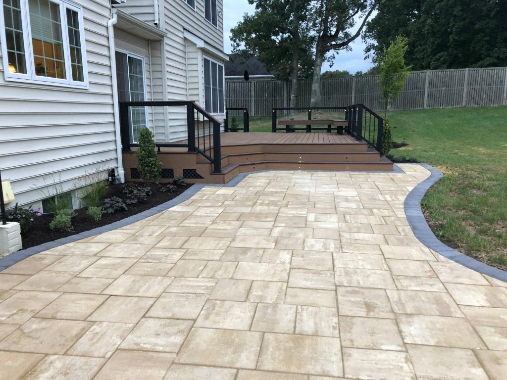 New stone patio leading to a slightly raised deck overlooking yard is a perfect way to prepare your yard for spring
