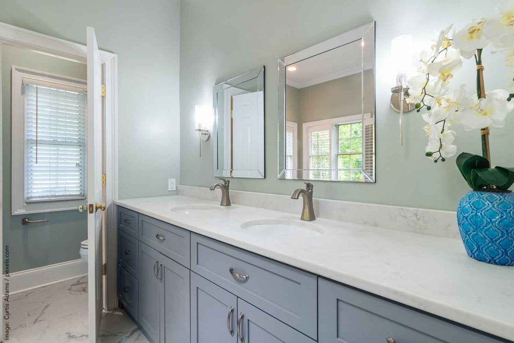 Modern batroom with pale blue vanity representing a 2024 color of the year choice