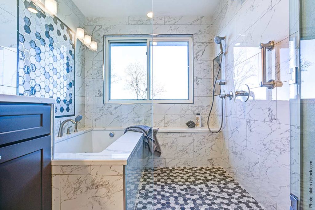 Representing bathroom trends for 2024 is this luxury bathroom with Marble tile Surround and mosaic accent wall