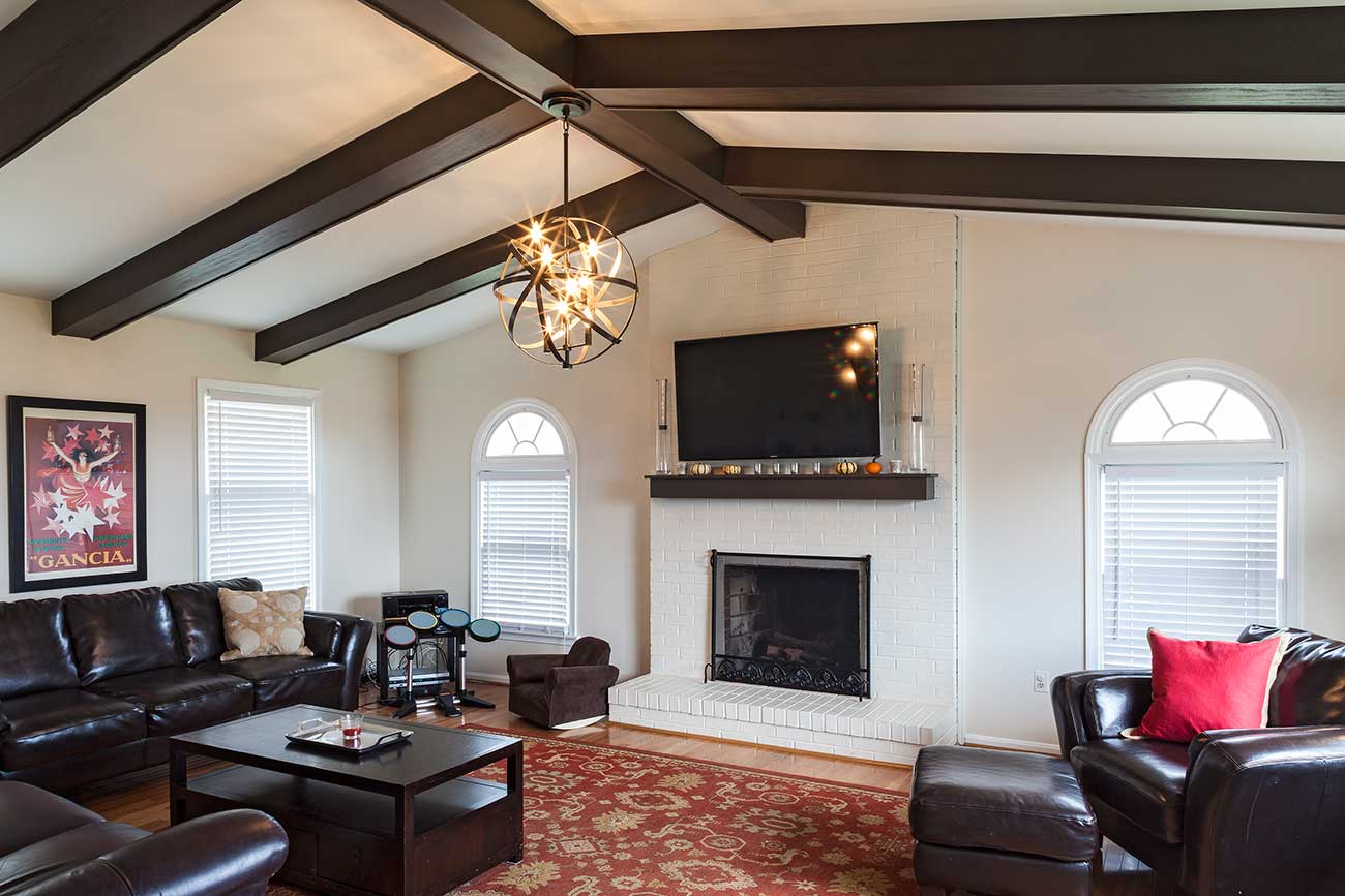 Livingroom with exposed beams and fireplace